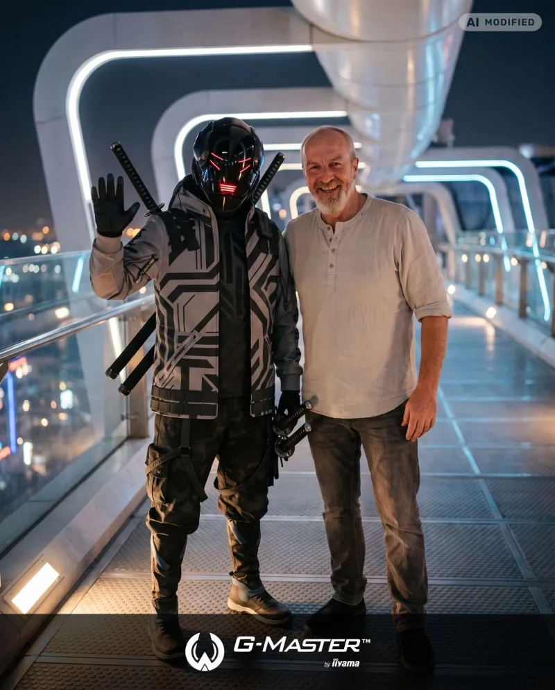 A visitor next to Titan Falcon on a futuristic bridge at night, framed with the G-Master by iiyama logo and an AI modified label.